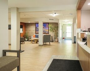 Reception lobby featuring open walkways, comfortable seating and a modern guest services area at Candlewood Suites Boise.