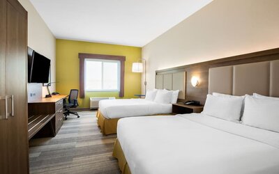 Guest room featuring two beds, a spacious layout, a work desk and contemporary furnishings designed for comfort at Holiday Inn Express & Suites Ontario.