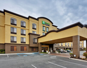 Hotel exterior featuring a covered entrance, contemporary architecture and convenient on-site parking at Holiday Inn Express SFO Airport North.