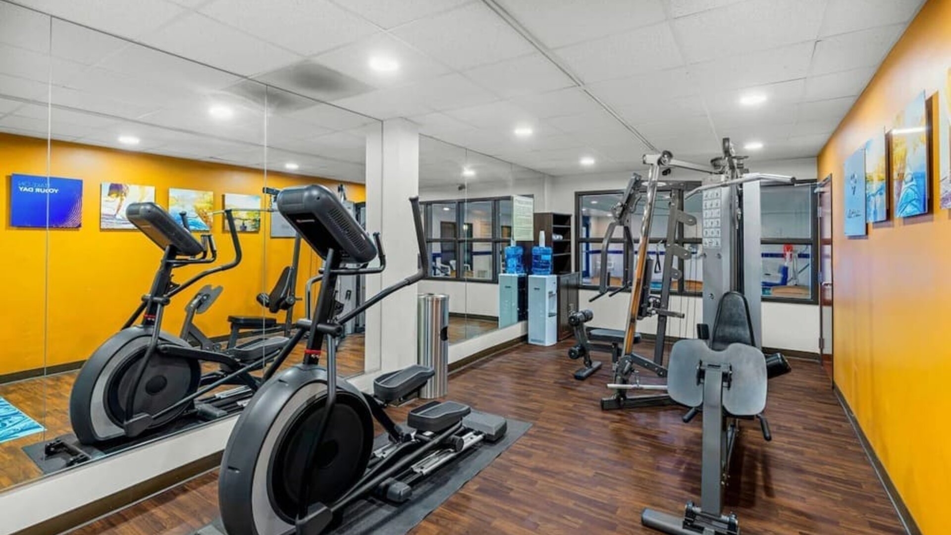 Fitness centre equipped with cardio machines, strength-training equipment, and mirrored walls at Comfort Suites Vacaville-Napa Valley Area.