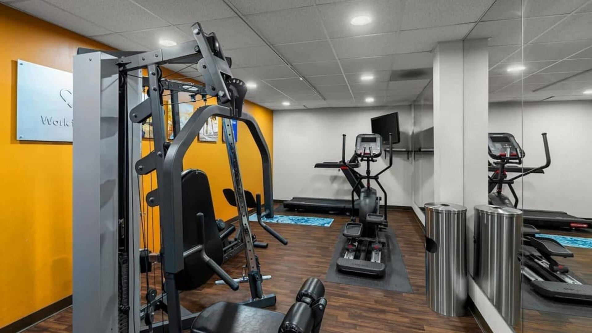 Fitness centre featuring strength-training equipment, cardio machines, mirrored walls, and ample workout space at Comfort Suites Vacaville-Napa Valley Area.