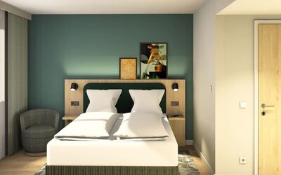 Bright modern hotel room with a double bed, crisp white bedding, teal accent wall, bedside reading lights, artwork, and a gray armchair by the window.