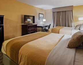 Guest room featuring two beds, flat-screen television, workspace, microwave, and mini refrigerator at Best Western Granbury Inn & Suites.