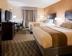 Guest room featuring two beds, flat-screen television, workspace, microwave, and mini refrigerator at Best Western Granbury Inn & Suites.