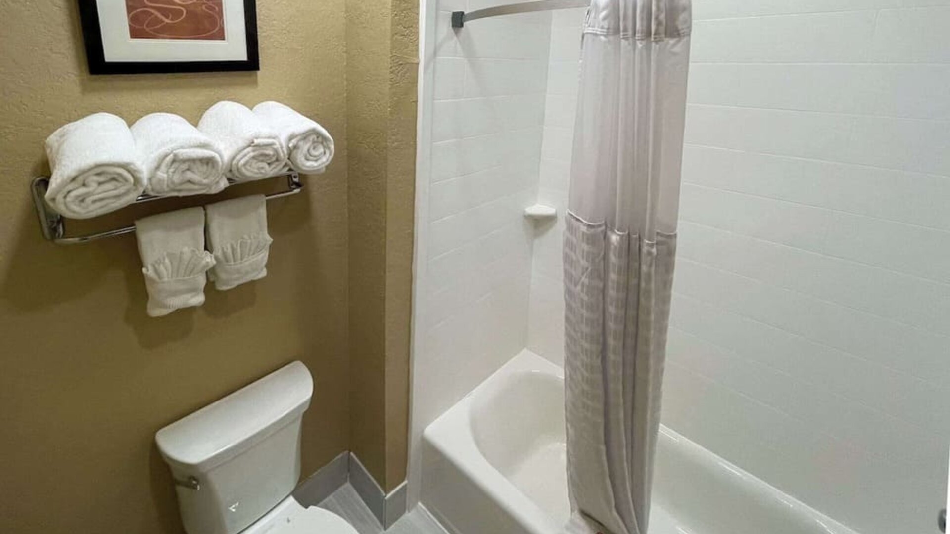 Guest bathroom vanity with two sinks, illuminated mirror, granite countertop, toiletries, and hair dryer at Comfort Suites San Antonio SeaWorld - Lackland AFB.