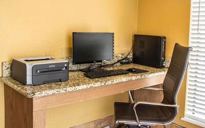 Business centre with desktop computer, printer, work desk, and office chair at Comfort Suites San Antonio SeaWorld - Lackland AFB.