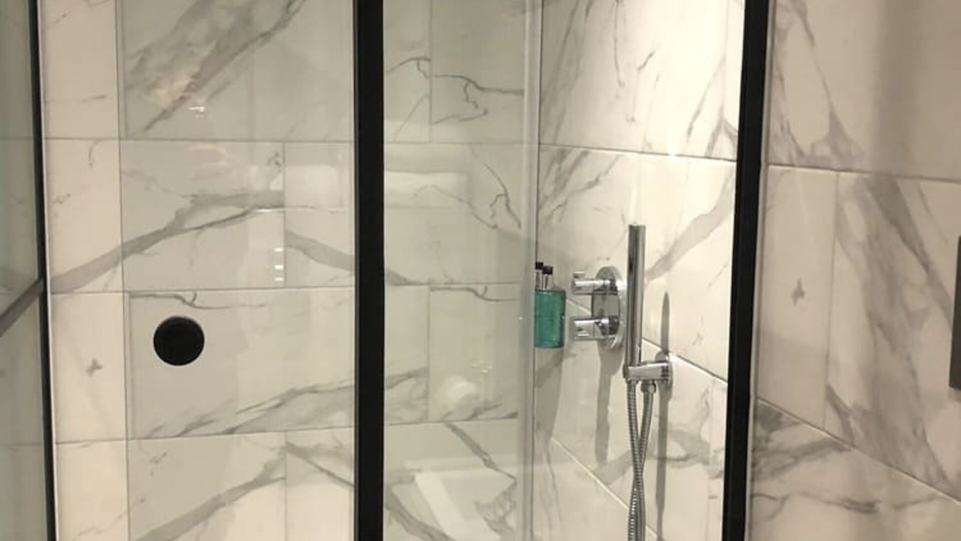 Guest bathroom with shower at Euston Square Hotel.