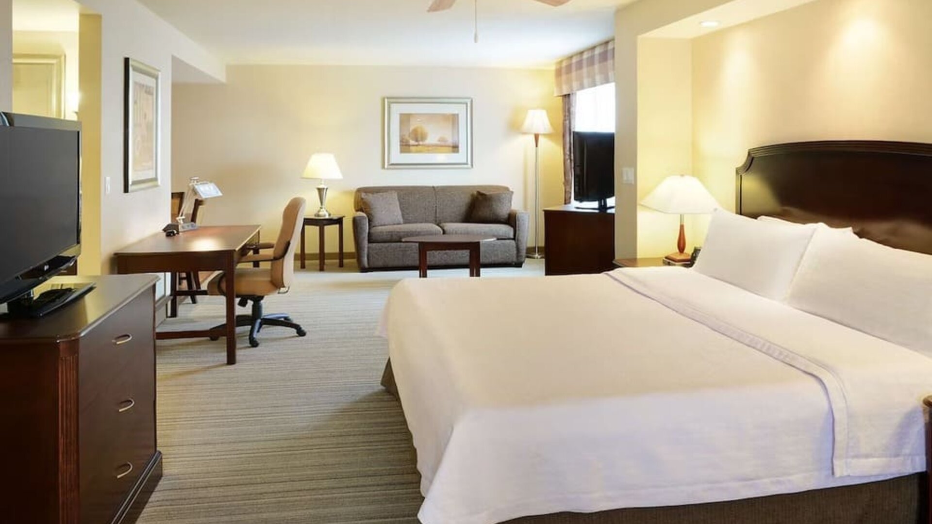 Day use studio suite with TV, work desk and living area at Homewood Suites By Hilton Burlington.