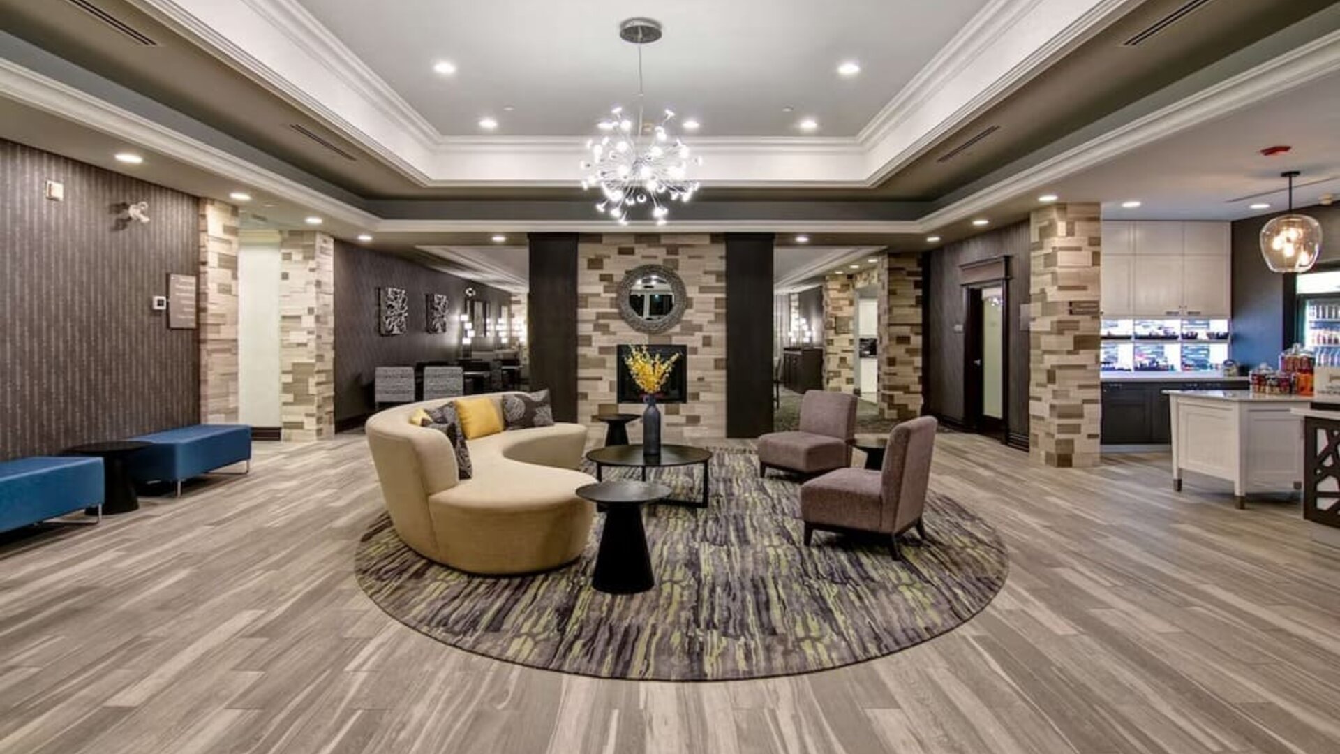 Hotel lobby with lounge area at Homewood Suites By Hilton Burlington.