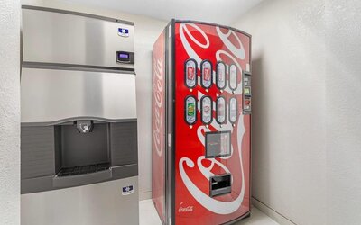 Ice machine and Coca-Cola beverage vending machine in a clean, well-lit hotel refreshment area.