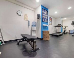 Fitness centre featuring a treadmill, exercise bike, elliptical machine, weight bench, and kettlebells. Best Western McCarran Inn.