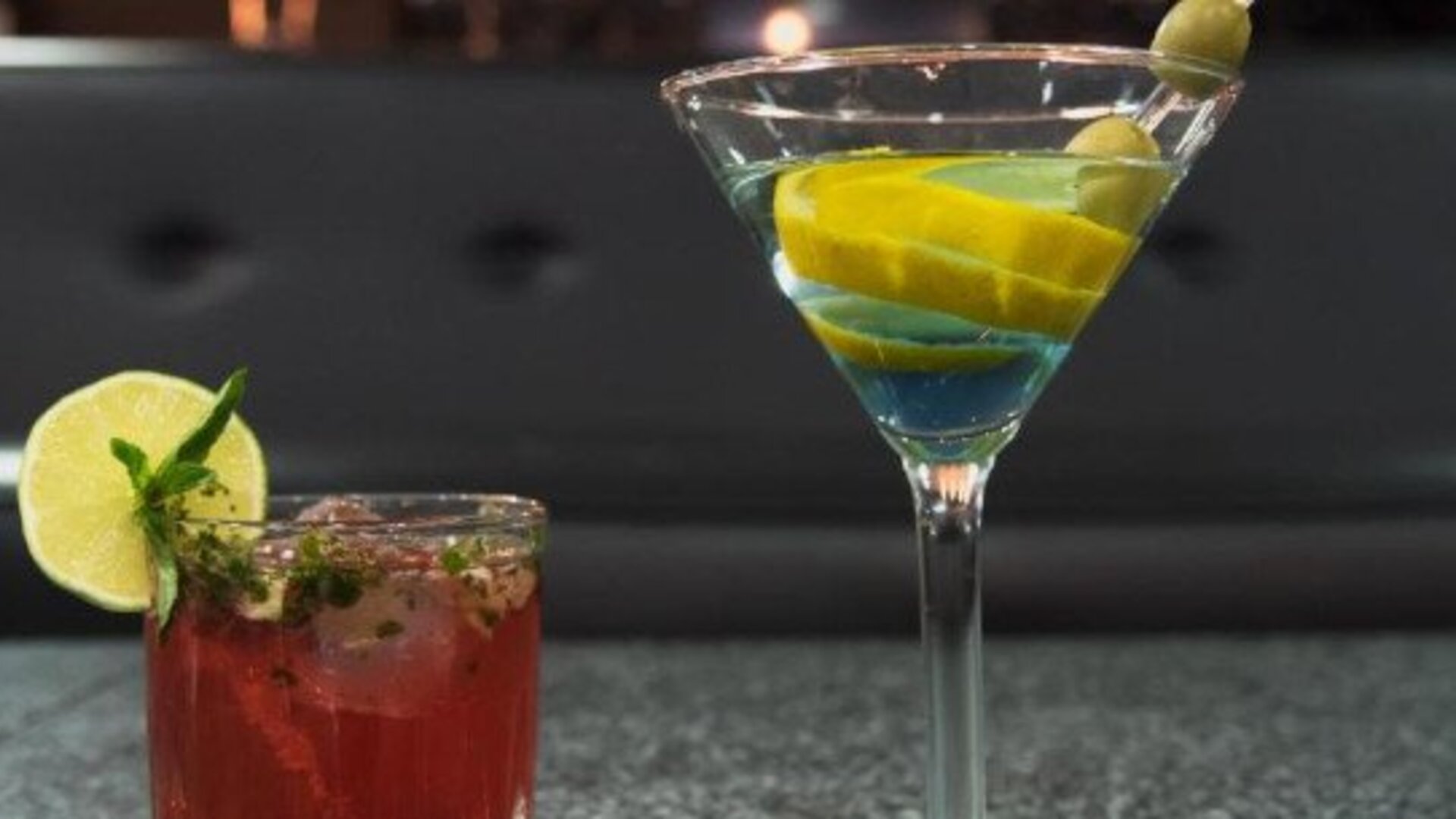 Two colourful cocktails served at the hotel bar, including a martini garnished with olives and citrus. LaiLa Hotel CDMX.