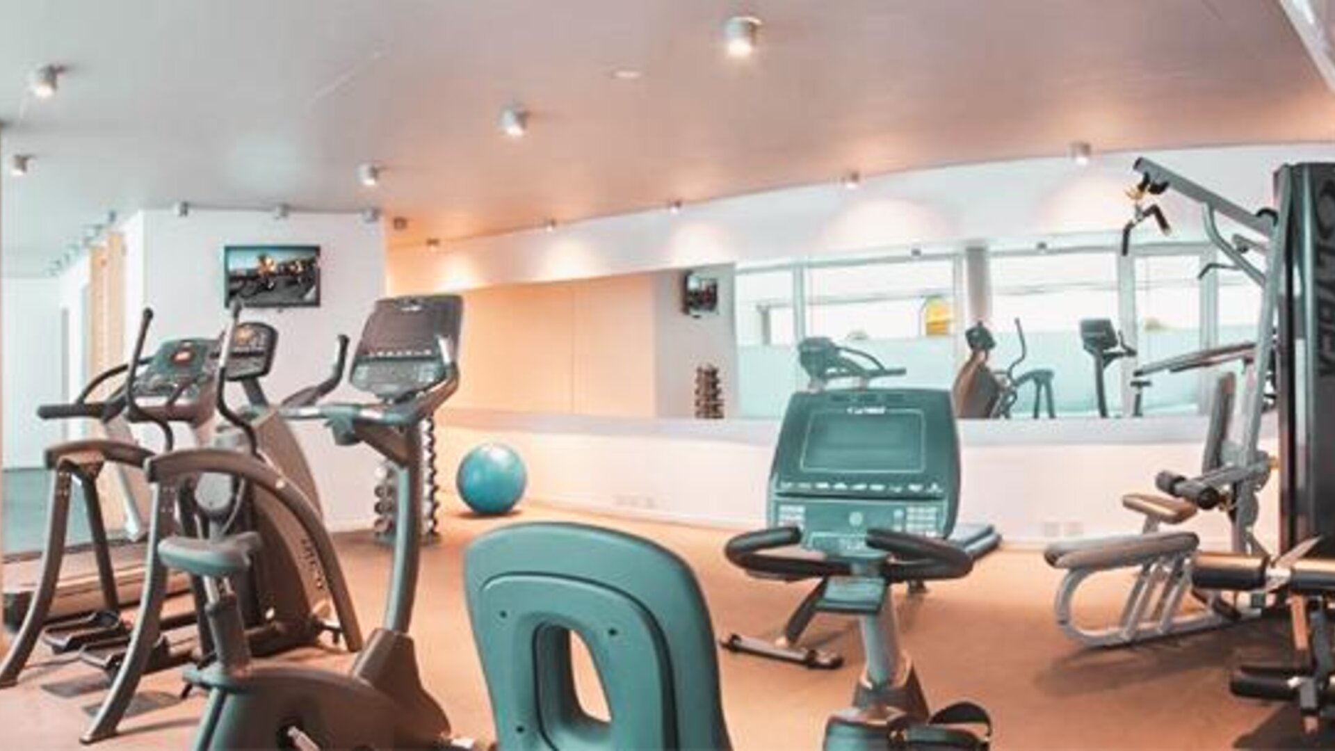 Fitness center with treadmills, stationary bikes, strength equipment, exercise ball, and mirrored walls at Dazzler by Wyndham Buenos Aires Recoleta.