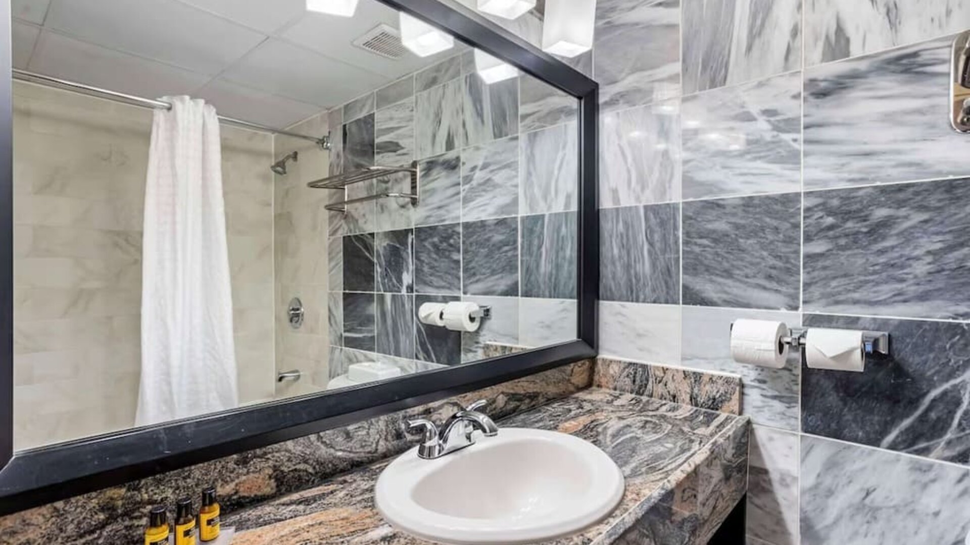 Guest bathroom with shower at Best Western Plus Newark Airport West.