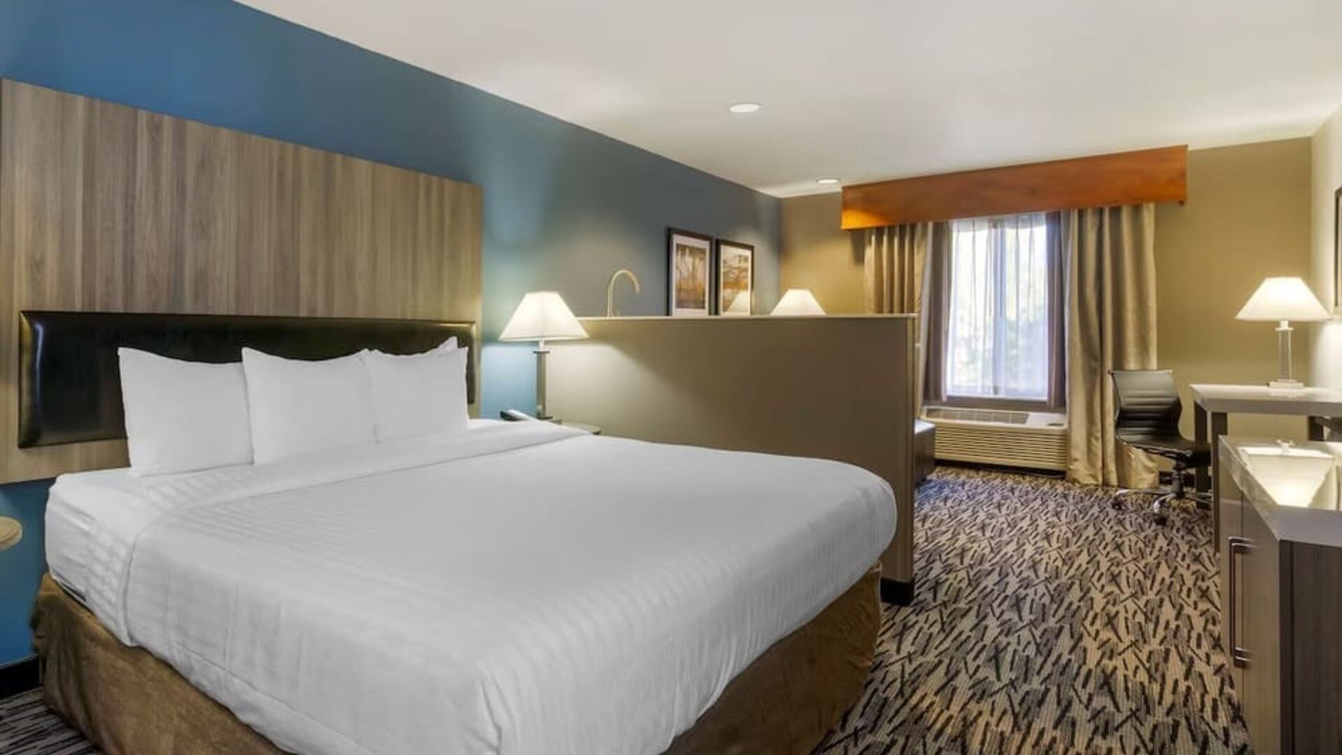 King guest room with large bed, bedside tables, desk, and window at Best Western Plus Mountain View Auburn Inn.