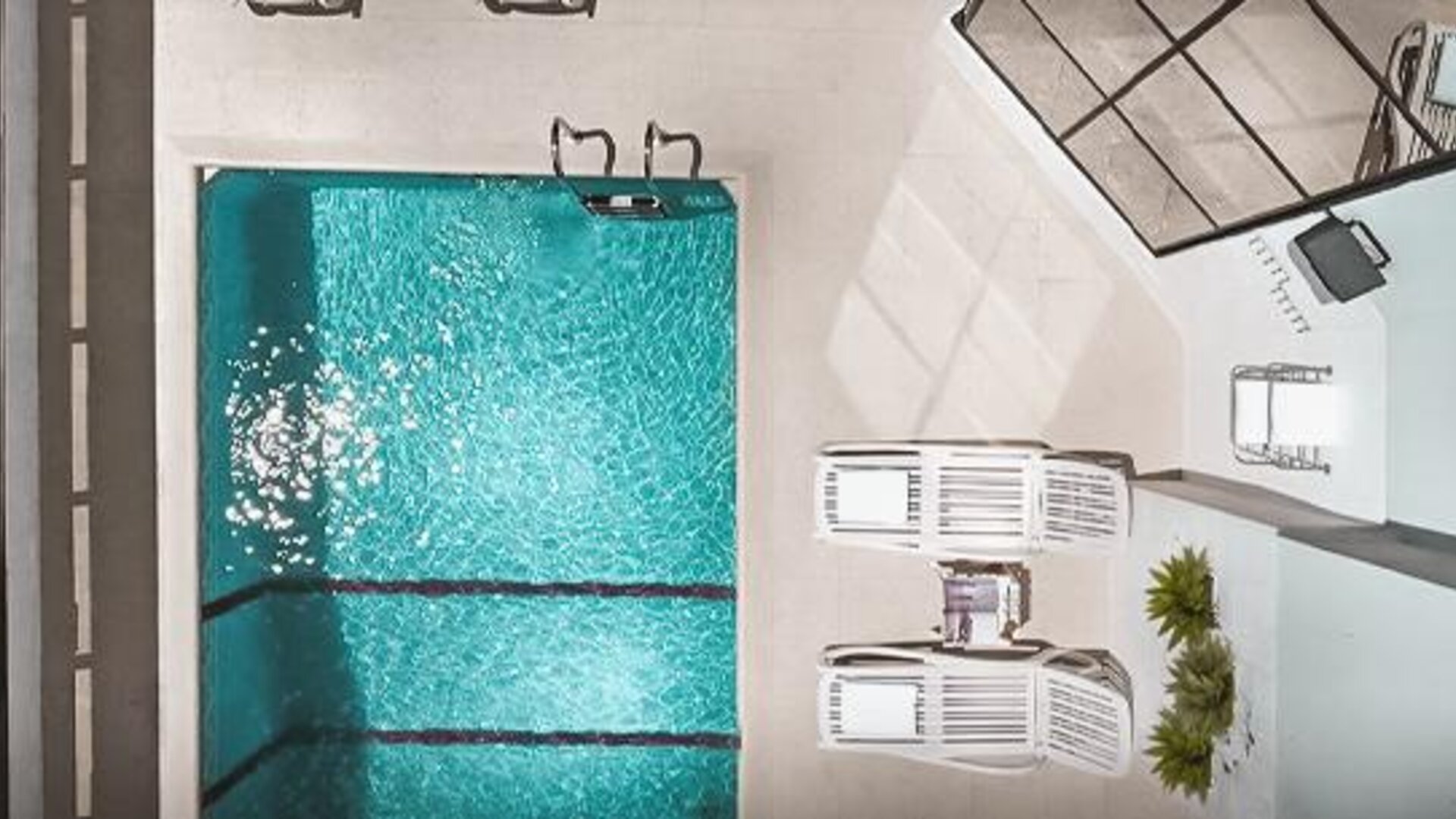 Outdoor swimming pool viewed from above, surrounded by lounge chairs and a paved pool deck at Ramada by Wyndham Buenos Aires Centro.