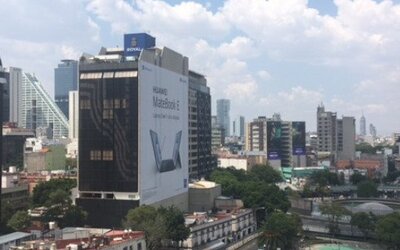 View of Mexico City’s modern skyscrapers and surrounding urban buildings through the windows at Hotel Block Suites.