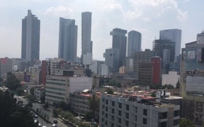 Daytime cityscape featuring high-rise office buildings, commercial streets and distant skyline views at Hotel Block Suites.