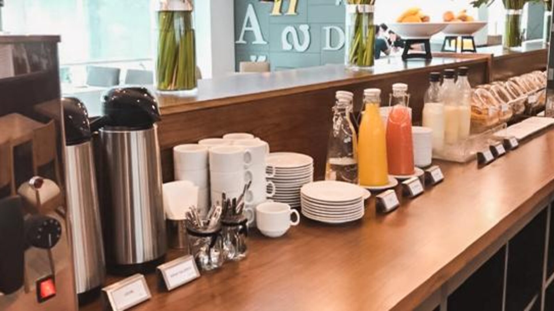 Breakfast coffee station with coffee machines, cups, saucers, juice bottles and pastries at Howard Johnson Plaza Buenos Aires.