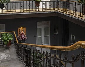 Hotel exterior showing a multi-storey building with balconies and a rooftop terrace at Hotel Principal.