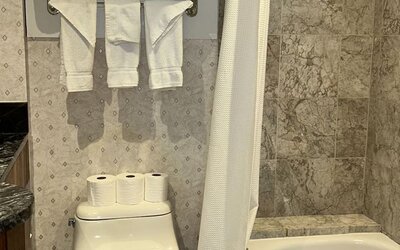 Private guest bathroom with tub at Parc Suites Hotel.