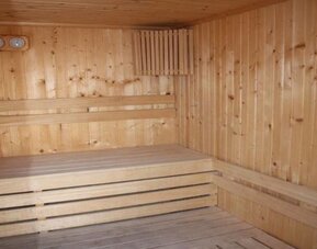 Wooden sauna room with tiered timber benches at Prima Music Eilat.
