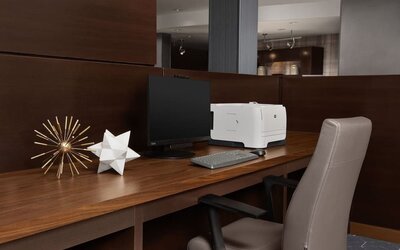 Business center with computer monitor, printer, keyboard, decorative ornaments and a wooden workstation at Courtyard By Marriott Dothan.