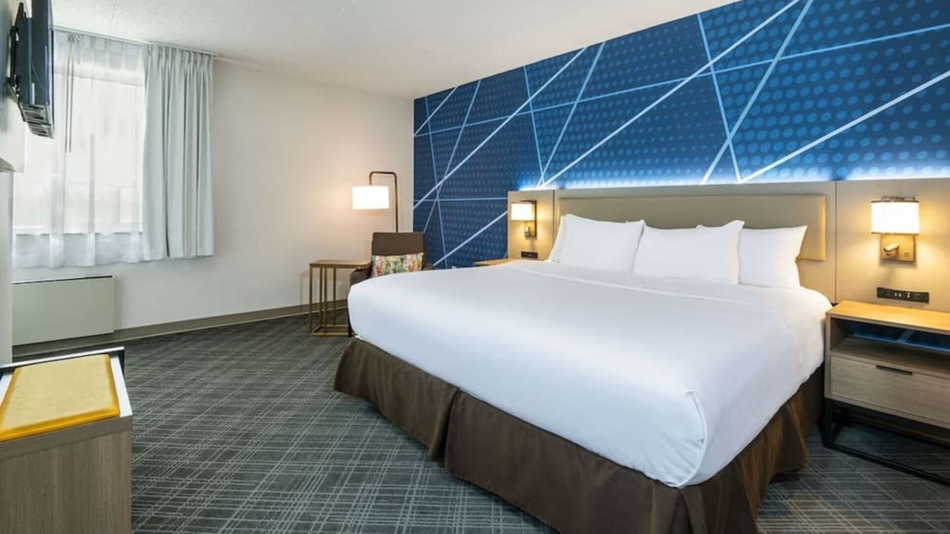 Spacious day use room with king bed, TV, sofa and private bathroom at Comfort Inn & Suites Barrie.