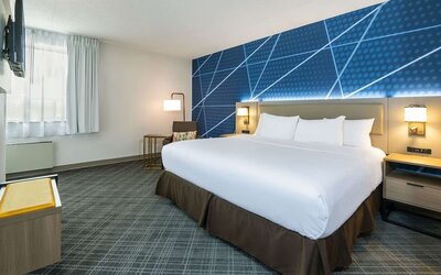 Spacious day use room with king bed, TV, sofa and private bathroom at Comfort Inn & Suites Barrie.