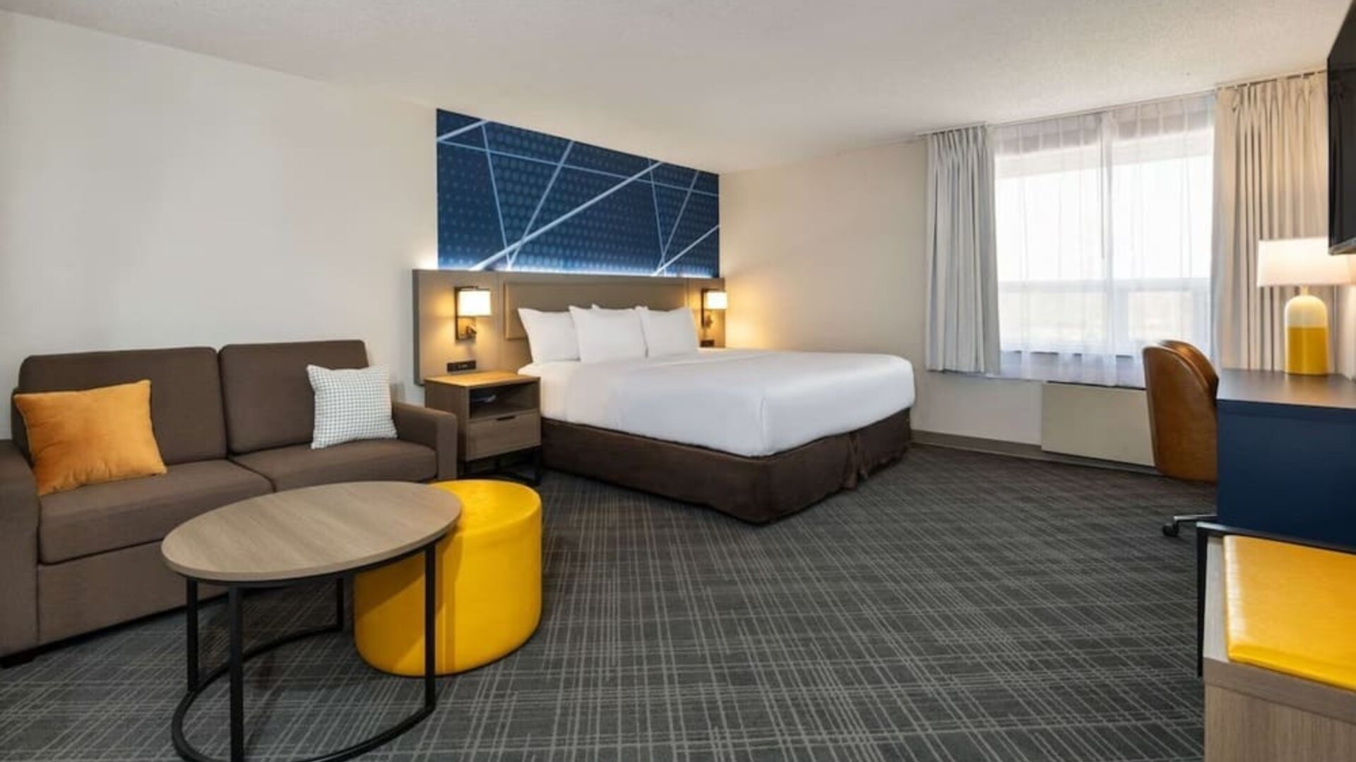 Day use room with work desk, TV, sofa and private bathroom at Comfort Inn & Suites Barrie.