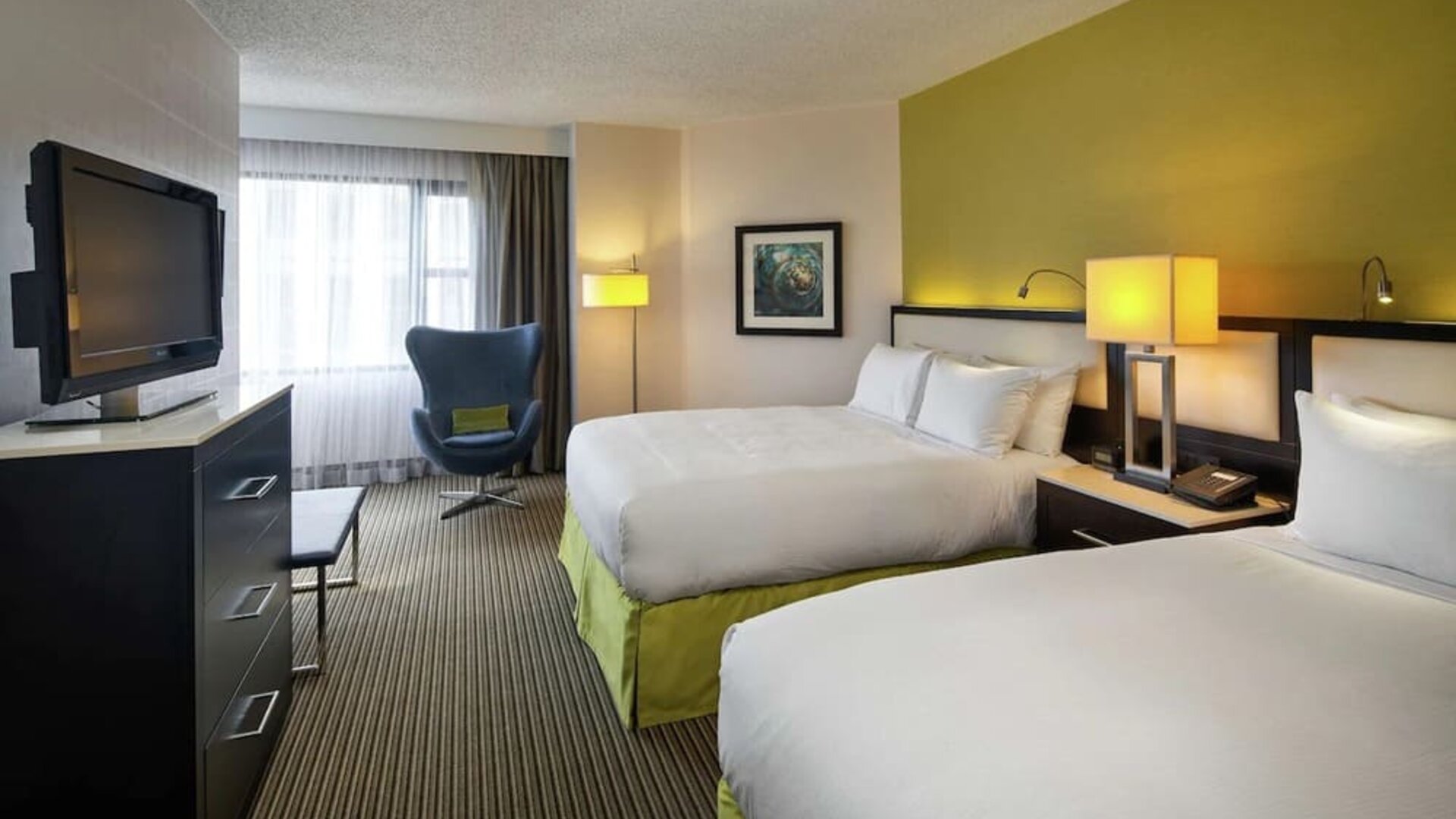 Day use twin room with TV and seating  at The Hollis Halifax - A DoubleTree Suites By Hilton.