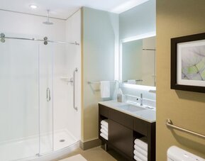 Private guest bathroom with shower at The Hollis Halifax - A DoubleTree Suites By Hilton.