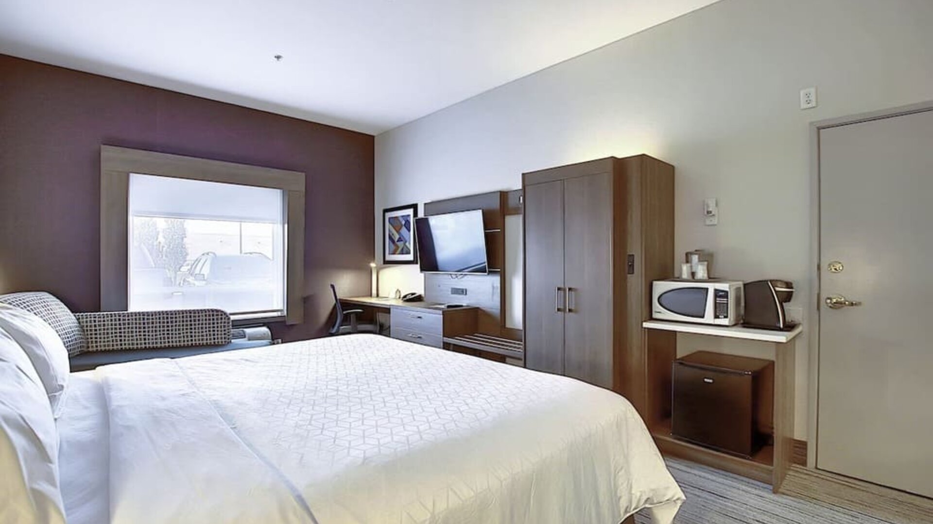 Spacious delux king room with TV and work desk at Holiday Inn Express & Suites Airport-Calgary.