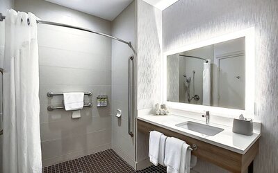 Day use guest bathroom with shower and toiletries at Holiday Inn Express & Suites Airport-Calgary.