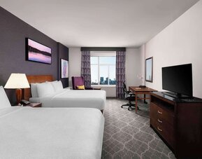 Comfortable twin room with TV, work desk and private bathroom at Hilton Garden Inn Calgary Airport.
