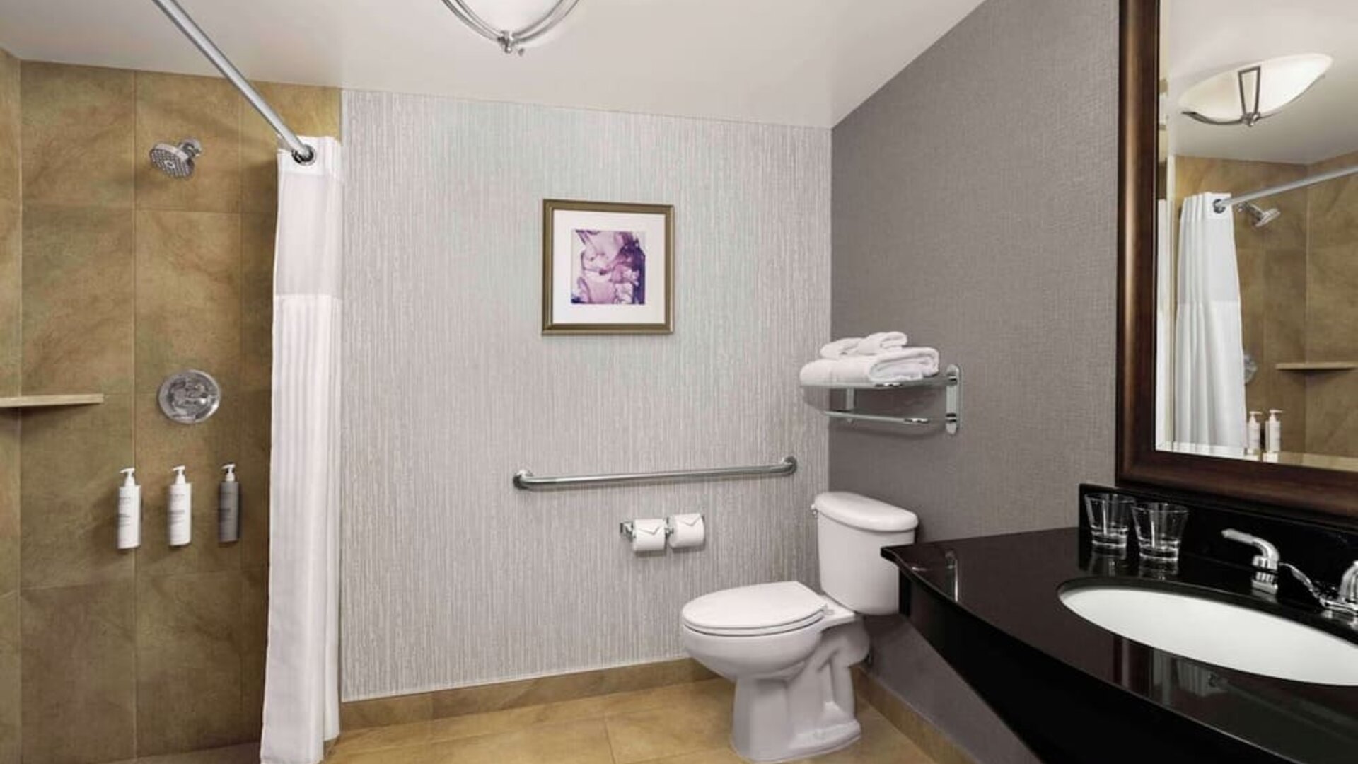 Day use guest bathroom with shower and toiletries at Hilton Garden Inn Calgary Airport.