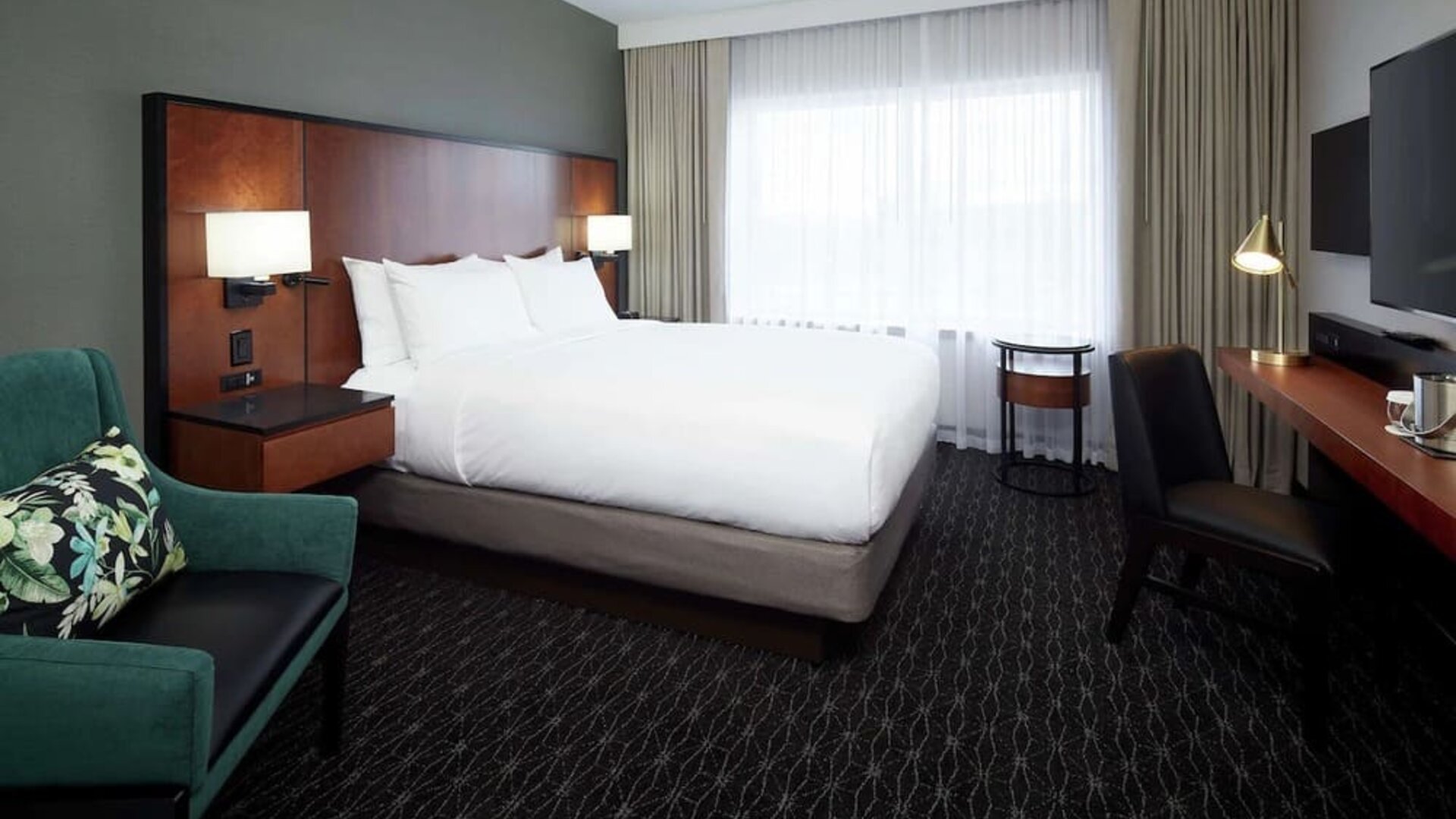 Day use room with TV, sofa, work desk and private bathroom at DoubleTree By Hilton Montreal Airport.