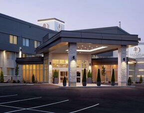 Hotel entrance and parking area at DoubleTree By Hilton Montreal Airport.