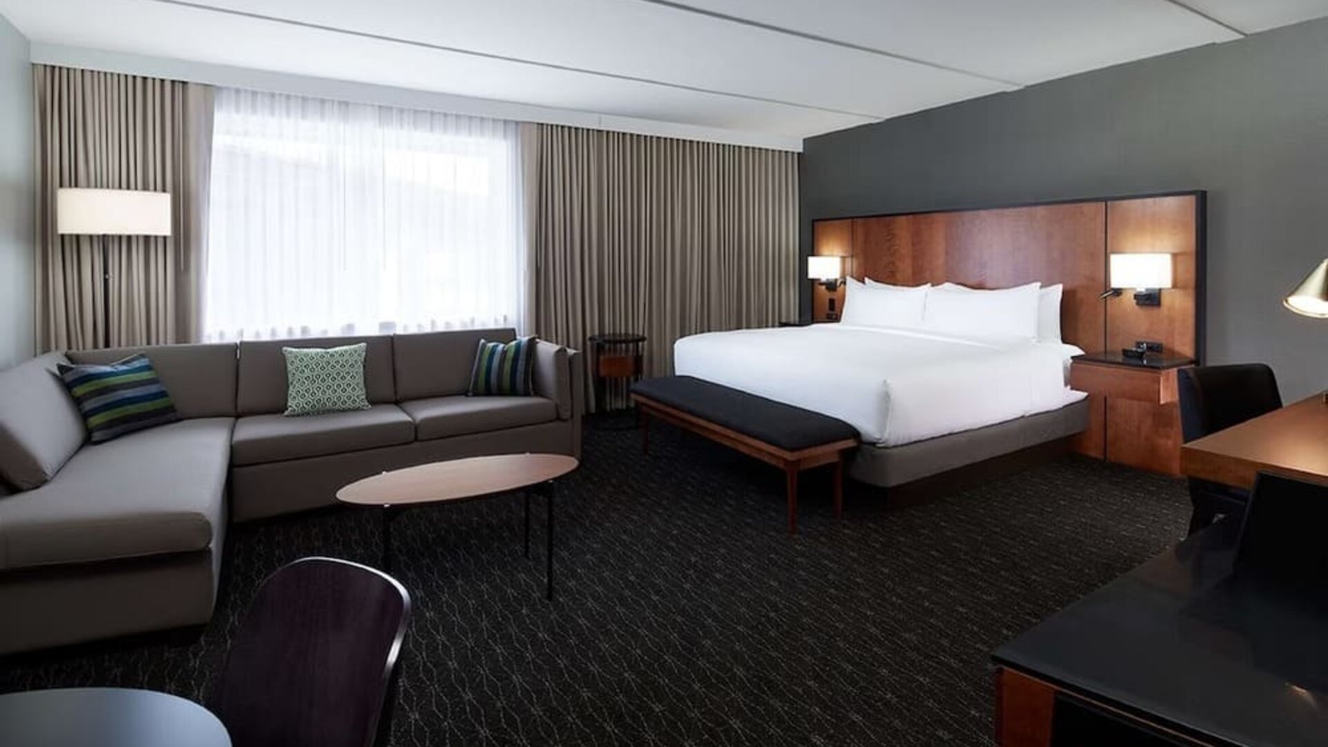 Bright and spacious studio suite with living area, workspace and private bathroom at DoubleTree By Hilton Montreal Airport.