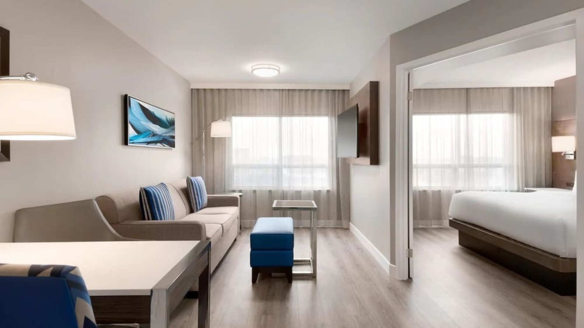 Bright and spacious studio suite with living area and work desk at the Embassy Suites by Hilton Montreal Airport.