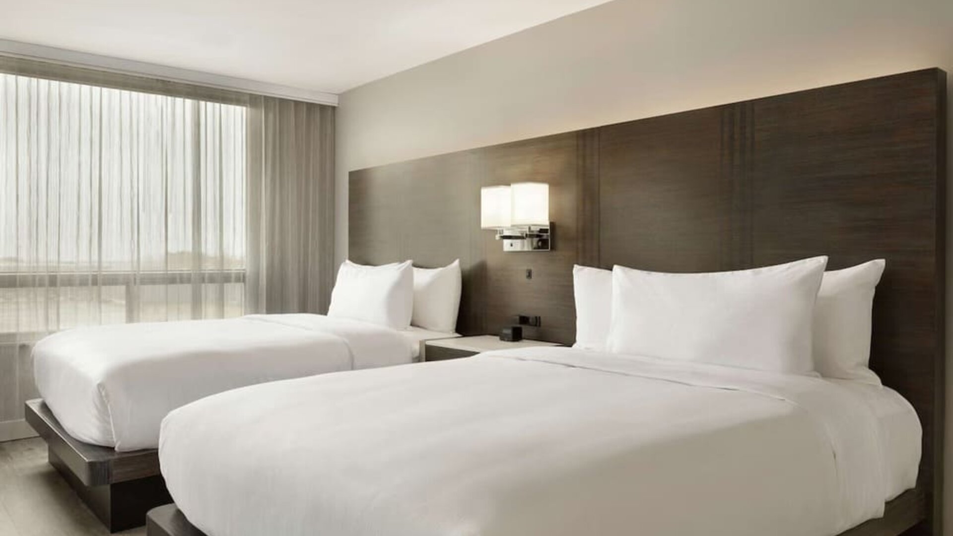 Twin room with private bathroom at the Embassy Suites by Hilton Montreal Airport.