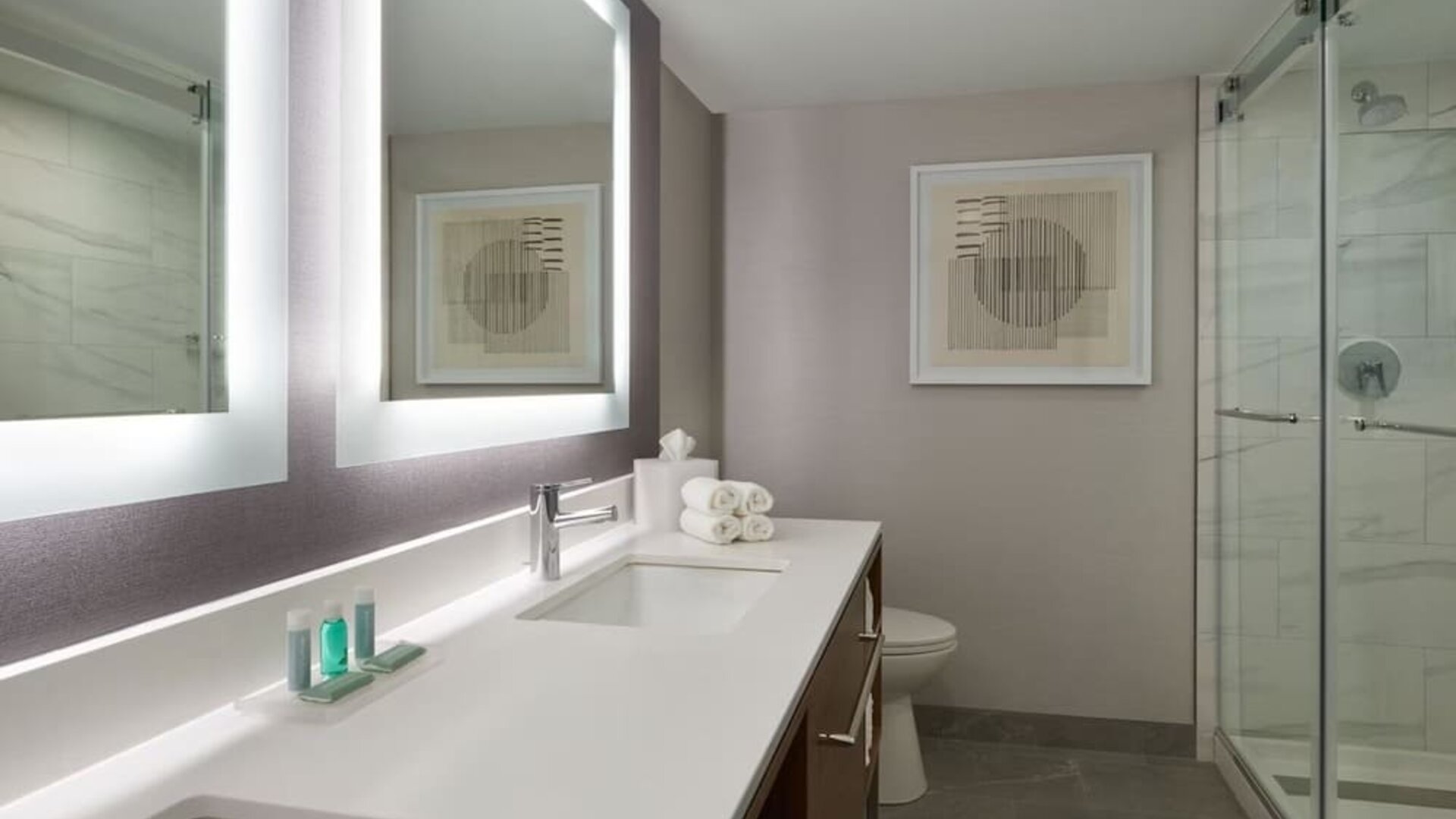 Guest bathroom with shower at Courtyard By Marriott Kitchener.