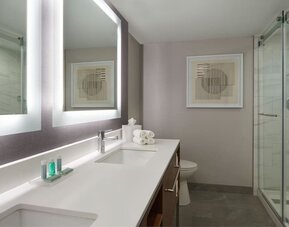 Guest bathroom with shower at Courtyard By Marriott Kitchener.
