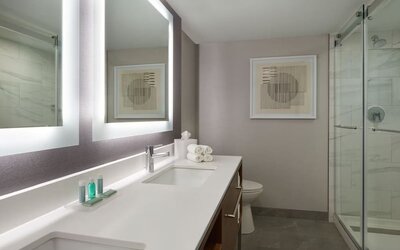 Guest bathroom with shower at Courtyard By Marriott Kitchener.