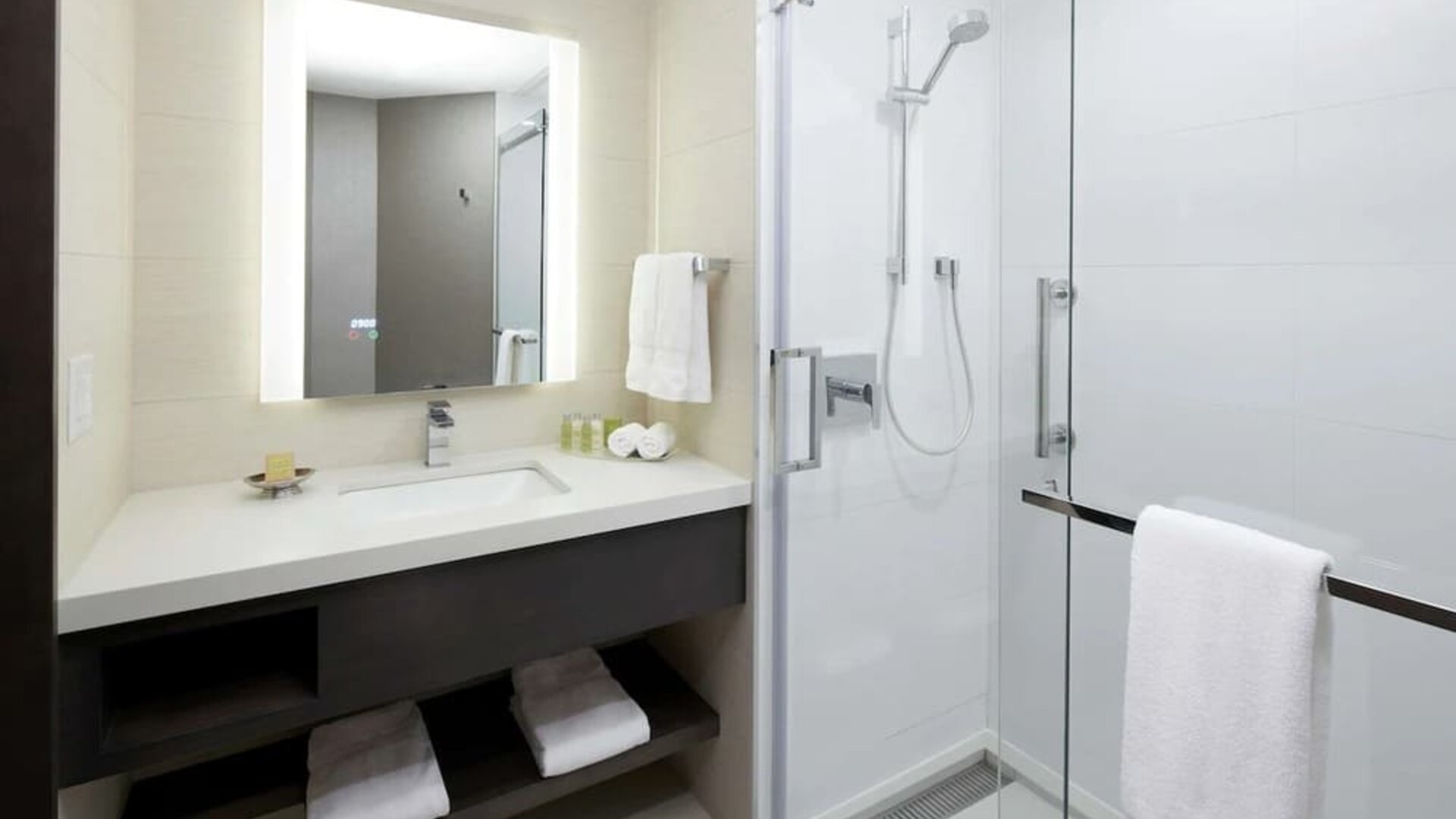 Private guest bathroom with shower and free toiletries at DoubleTree By Hilton Montreal.