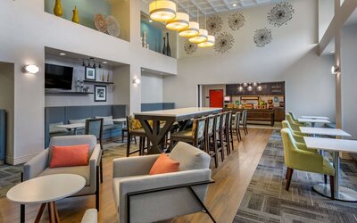 Hotel dining area with comfortable seating, perfect for co-working at Hampton Inn & Suites By Hilton Edmonton/West.