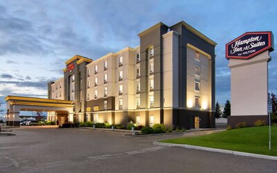 Hotel exterior and parking area at Hampton Inn & Suites By Hilton Edmonton/West.