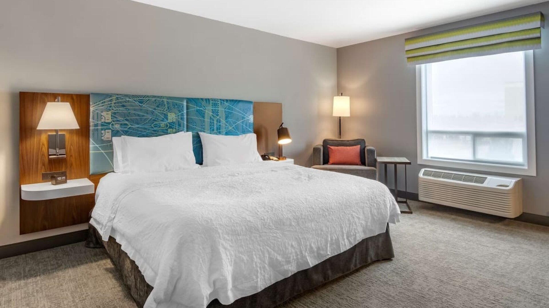 Standard day use room withking bed, TV, sofa and private bathroom at Hampton Inn & Suites By Hilton Edmonton/West.