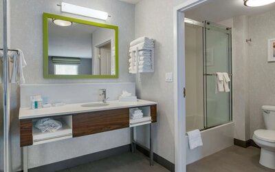 Private bathroom with shower and free toiletries at Hampton Inn & Suites By Hilton Edmonton/West.