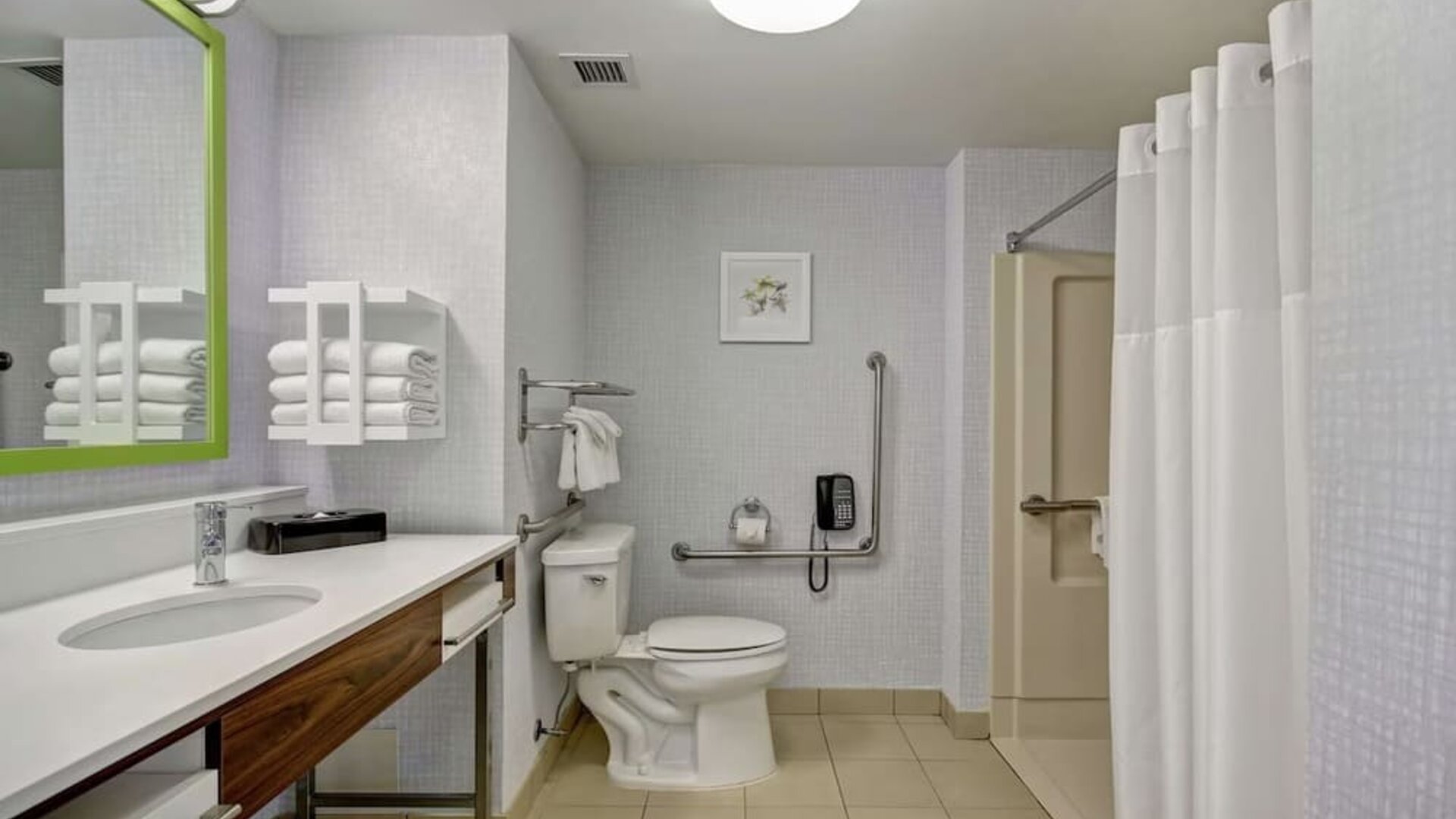 Private guest bathroom with shower and free toiletries at the  Hampton Inn & Suites By Hilton Guelph.